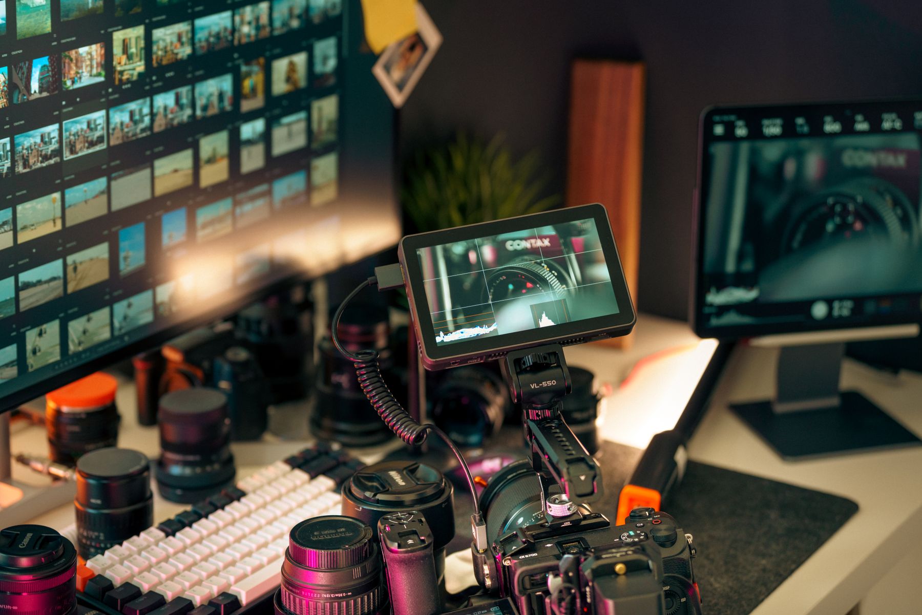 Camera and screens in a modern post-production workspace